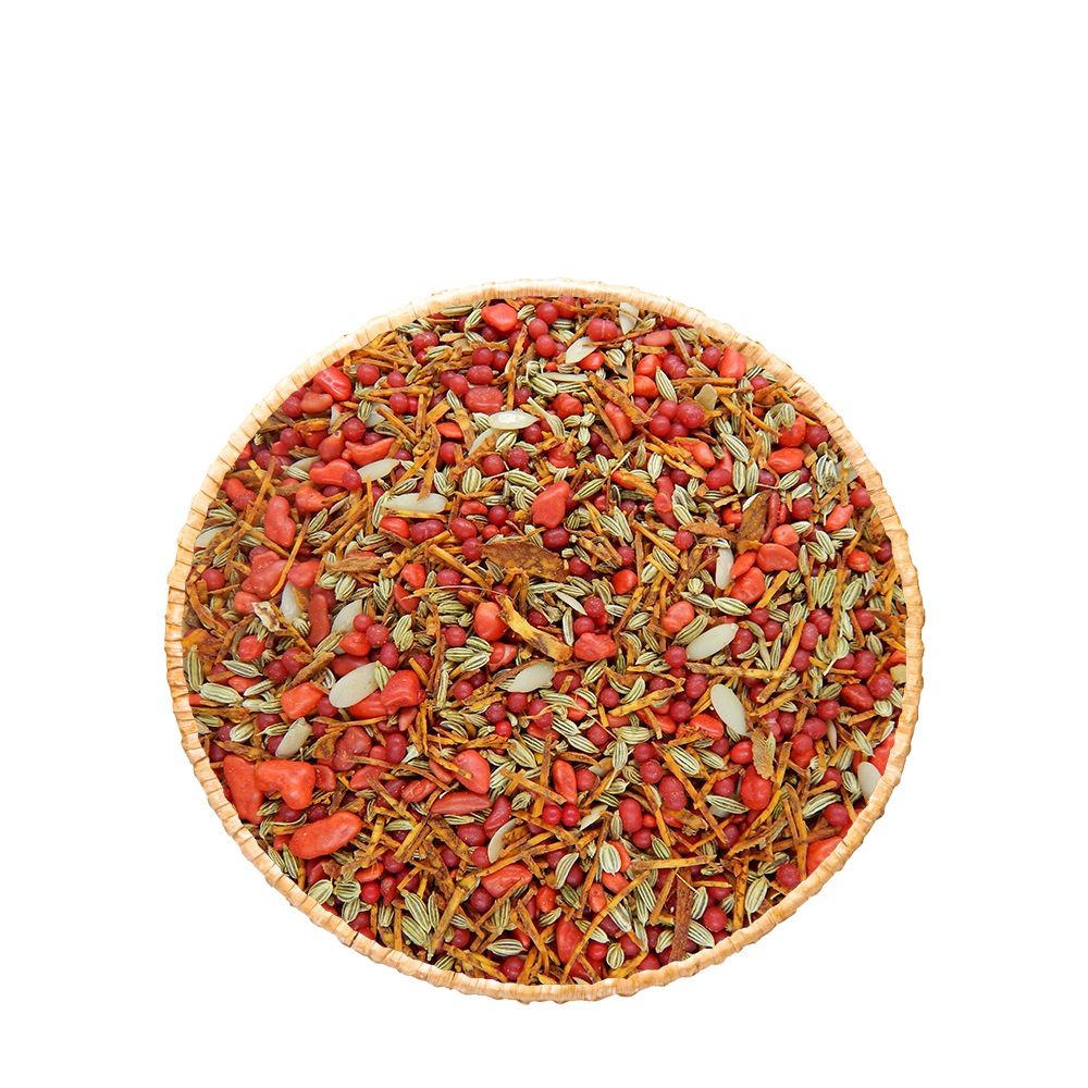 Mélange digestif indien Pan Masala Rouge dans un bol, composé de graines de fenouil, sucre, noix d'arec et graines de melon La Carte aux Épices.